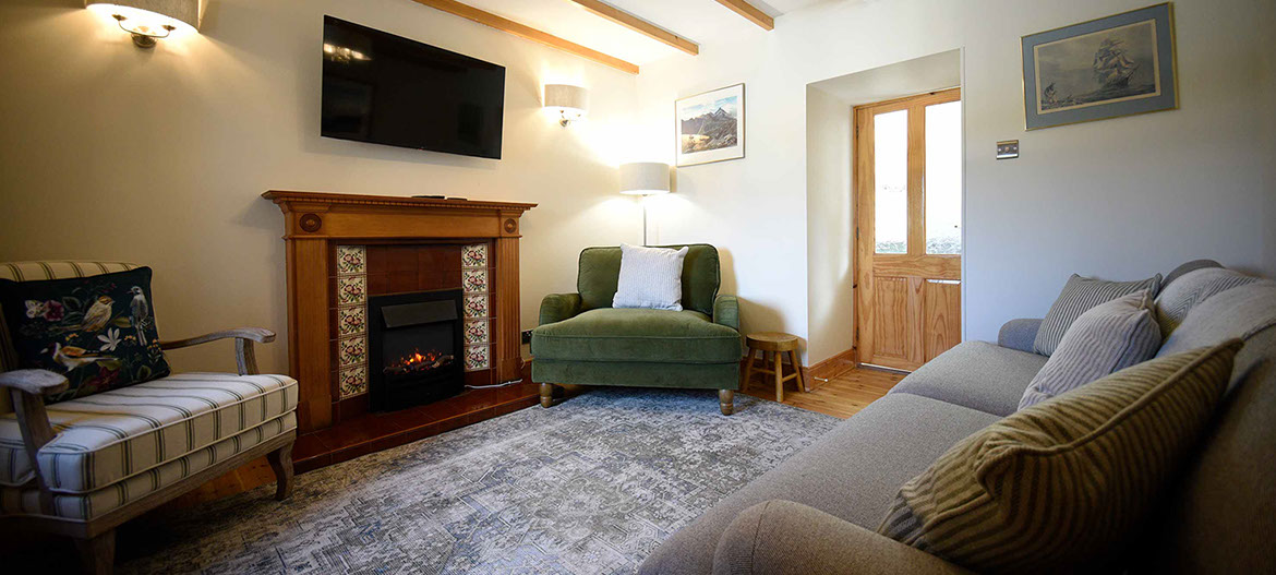 Caberfeidh Boat House self catering accommodation contains a cosy living room with widescreen TV electric fire and comfortable seating