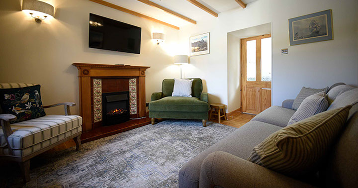 Caberfeidh Boat House self catering accommodation contains a cosy living room with widescreen TV electric fire and comfortable seating